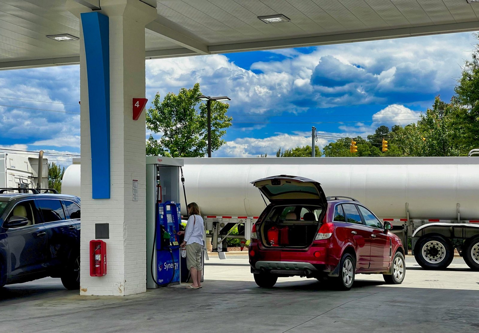 red car at a gas station