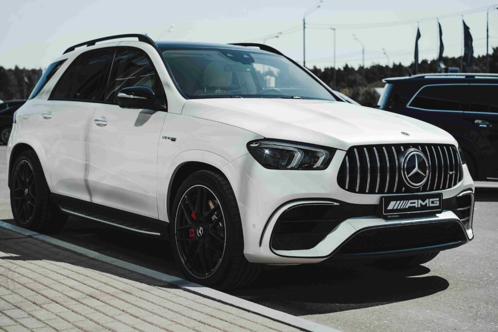 white splendid mercedes GLE car is standing on the road